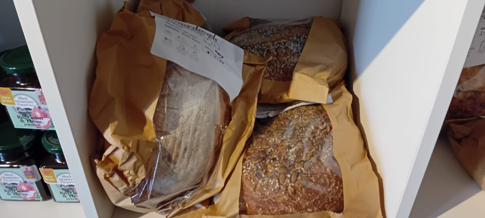 Fresh sourdough loaves wrapped in paper